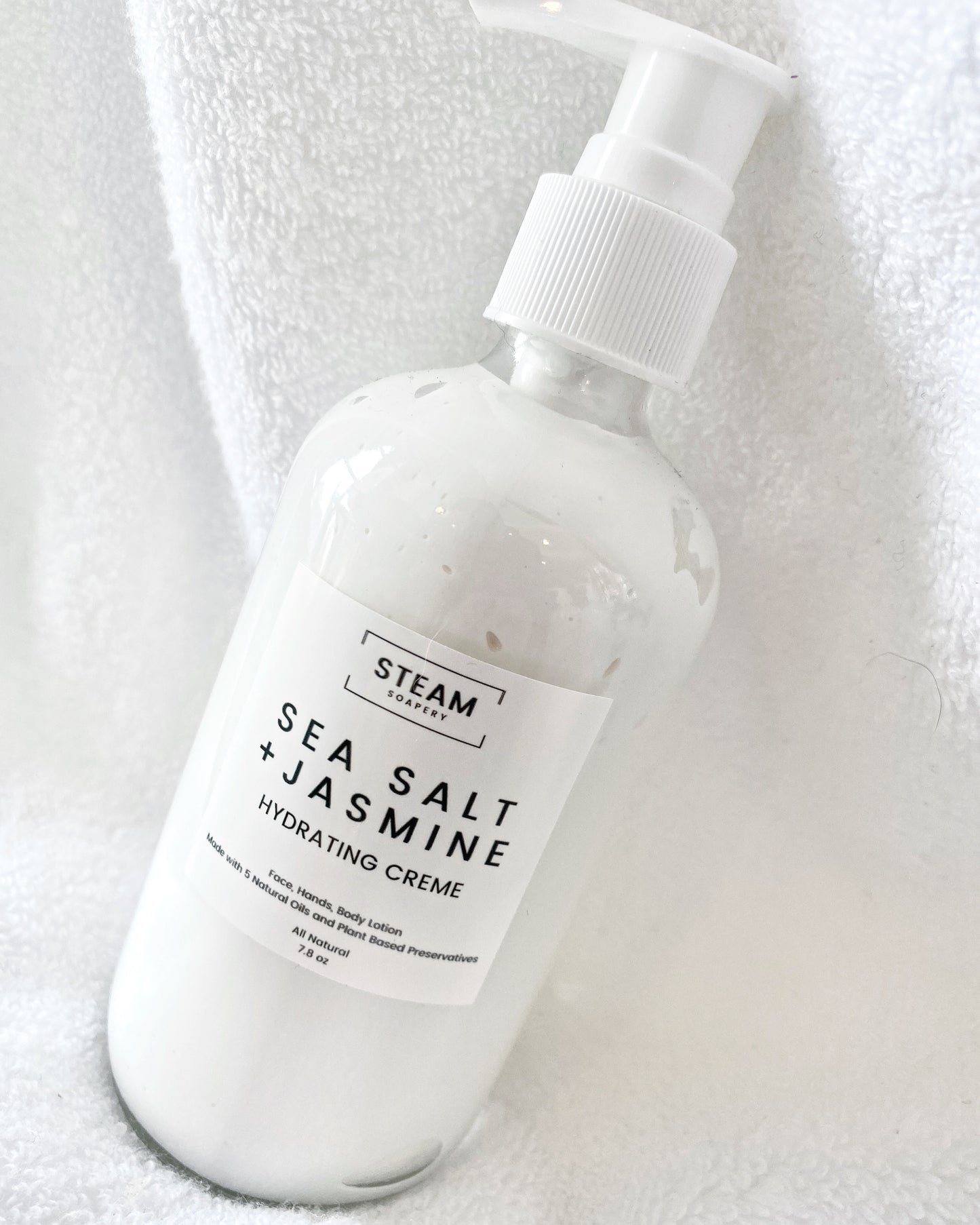 An 8oz Pump of our Sea Salt Jasmine Hydrating Creme in a Glass Bottle